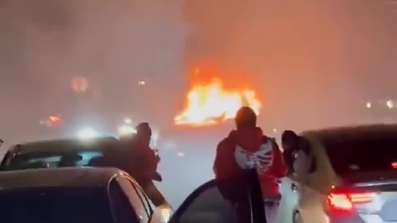 negro mixed mob do a street takeover,attack homeowner and burn security vehicle