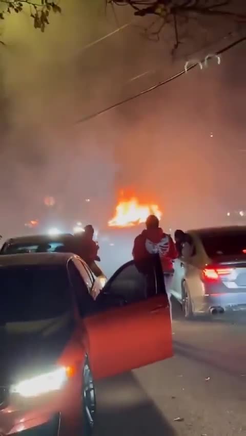 negro mixed mob do a street takeover,attack homeowner and burn security vehicle