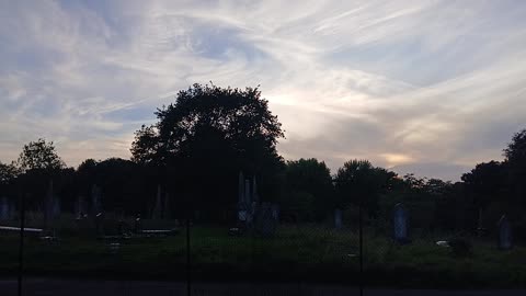 A visitor admired the crown/ halo / nimbus of cloud in the sky as worn by the statue of liberty.nim