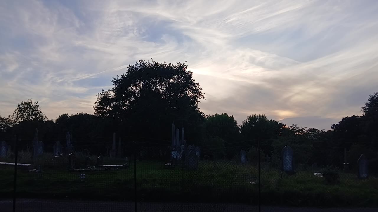 A visitor admired the crown/ halo / nimbus of cloud in the sky as worn by the statue of liberty.nim