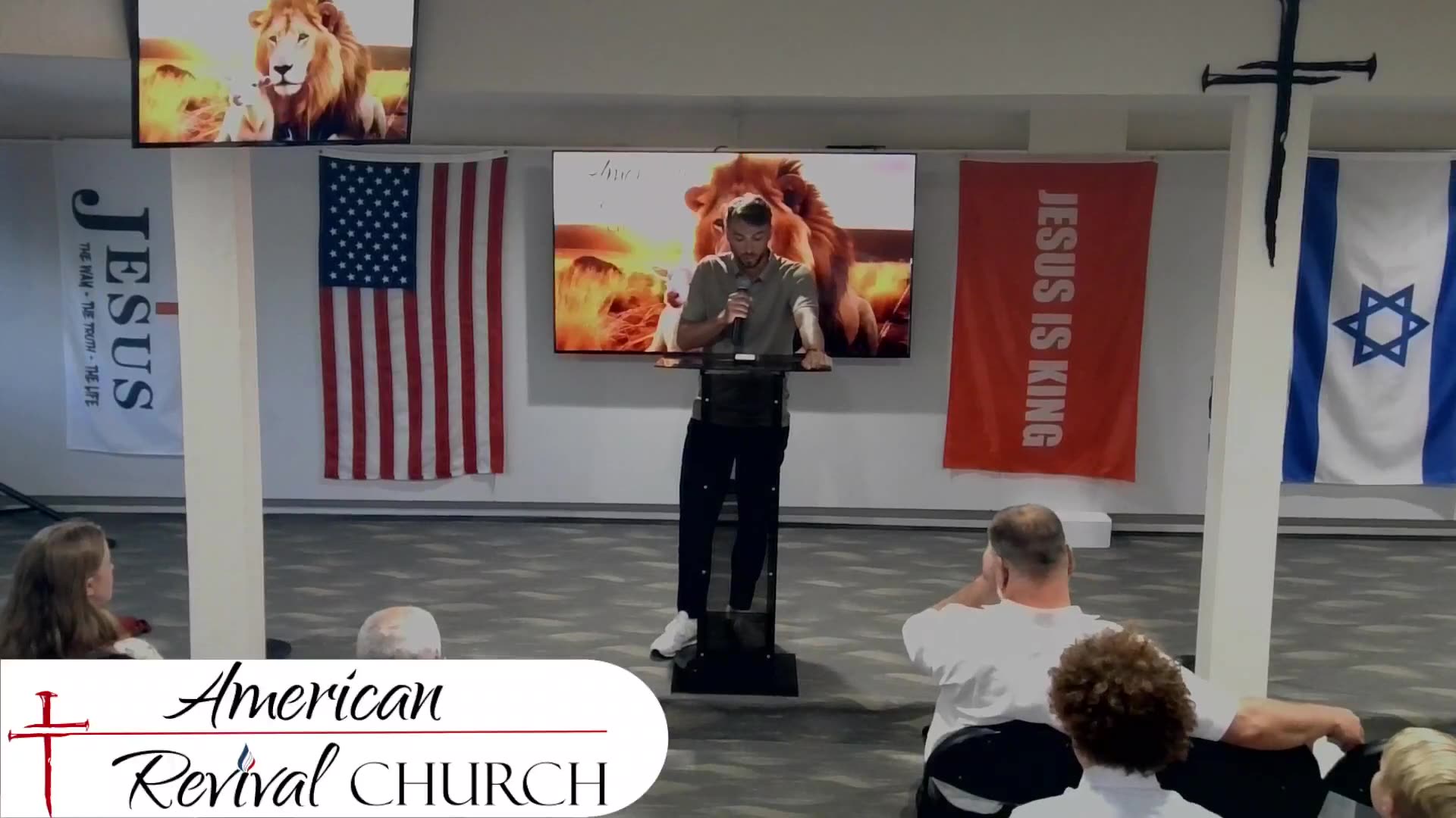 Nathaniel and Marzena Pawlowski speaking at the American Revival Church.