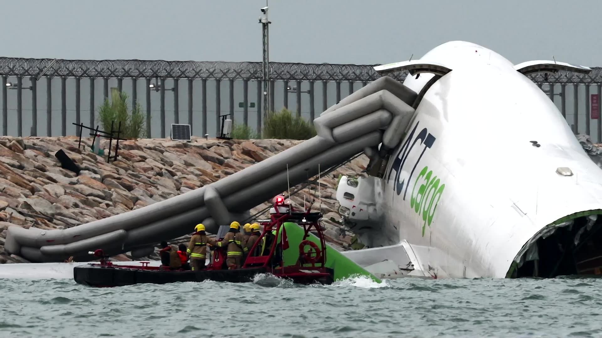 Cargo plane skids off Hong Kong runway, killing two staff