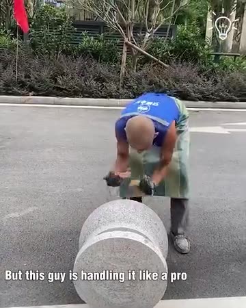 One man show putting down heavy sphere bollards on the road!