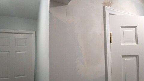 Mudding Water Damage Walls in Hall