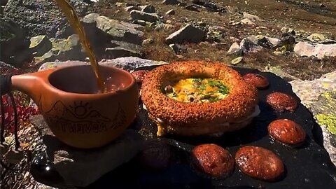 Eggs with beef sausage between bagels on the mountain