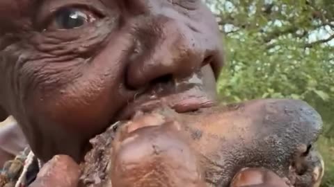 Hadzabe Old Man Enjoy Lunch Monkey Head