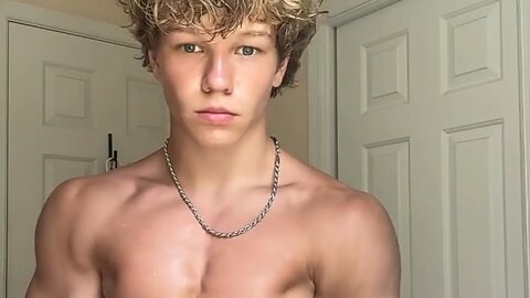 16 years old teen boy flexing muscles