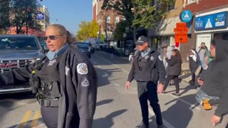 Chicago police clear the street after federal officers were confronted by a crowd in