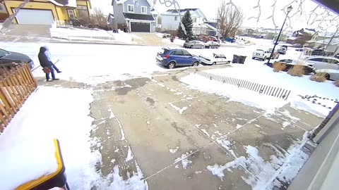 Kid slips on ice while carrying a shovel