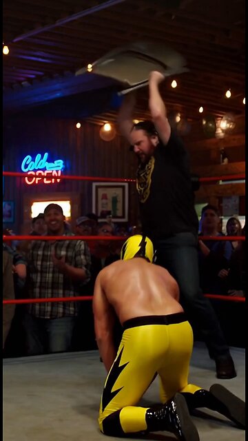 Russell Blade beats up a yellow mask wrestler with a chair