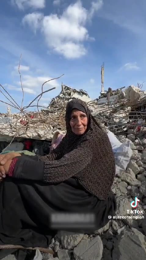 Mother sits on the ruins of her house - Asks for a pillow or a matteress