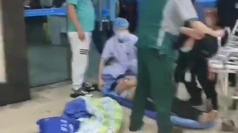 A man is crying, because the hospital refuses to treat his family member, who doesn't have a val..