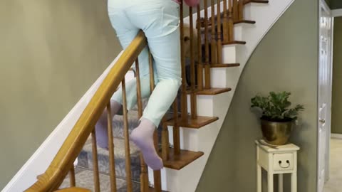 Playful Nan Slides Backward Down Banister