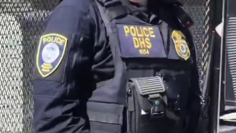 A fluffy Hispanic Woman parks her car in front of the ICE facility garage ramp in Los Angeles.