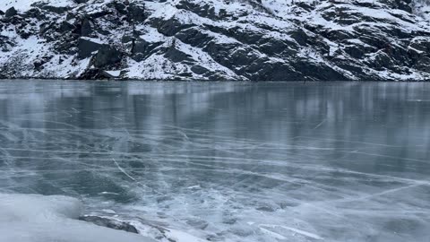 Glacier Breaks Onto Frozen Lake