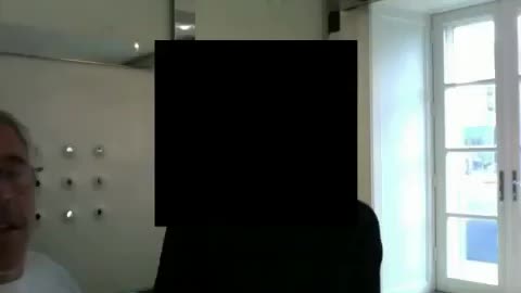 Jeffrey Epstein is captured parading a young girl in front of the camera like livestock at auction