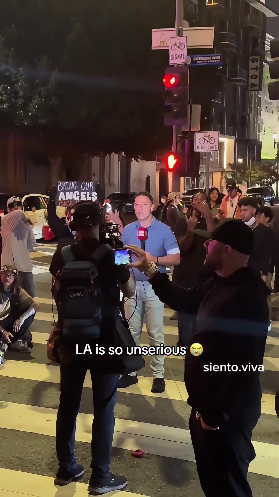 Downtown Los Angeles, a reporter is bombarded with Mexico Flag waiving ICE protesters screaming