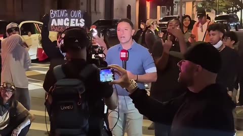 Downtown Los Angeles, a reporter is bombarded with Mexico Flag waiving ICE protesters screaming