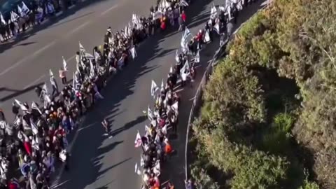 ADMIN POST. Israelis line the route of the funeral of leader