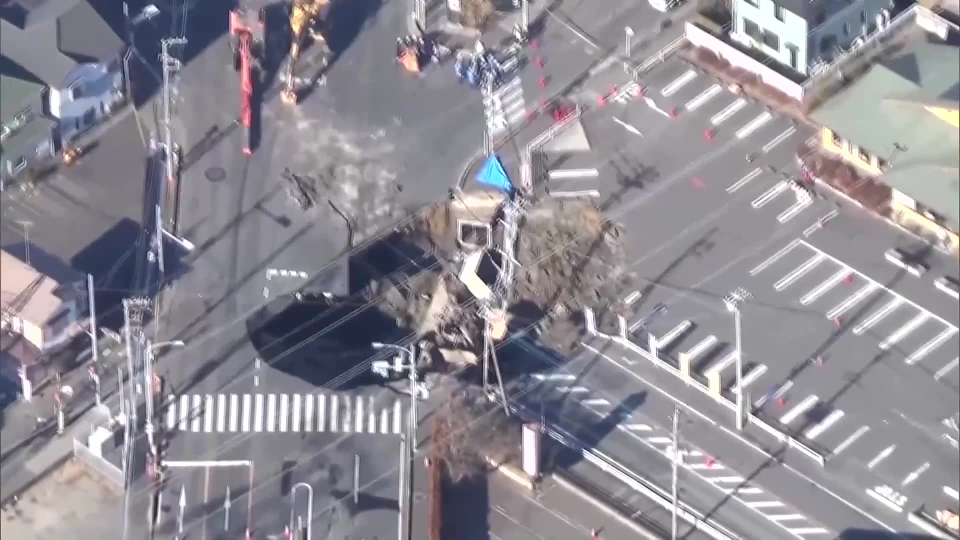 Rescuers try to reach driver stuck in Japan sinkhole