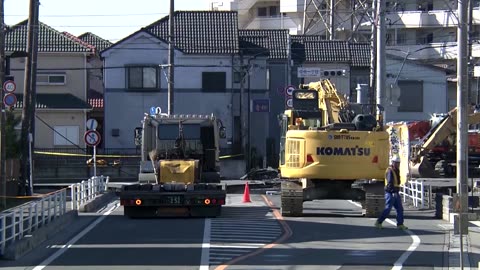 Rescuers try to reach driver stuck in Japan sinkhole