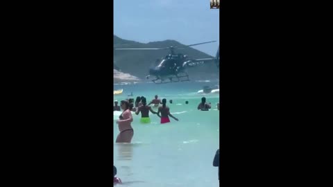 Brazilian police officer drops rifle into the sea.