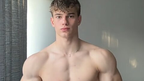 19 years old aesthetic bodybuilder flexing muscles