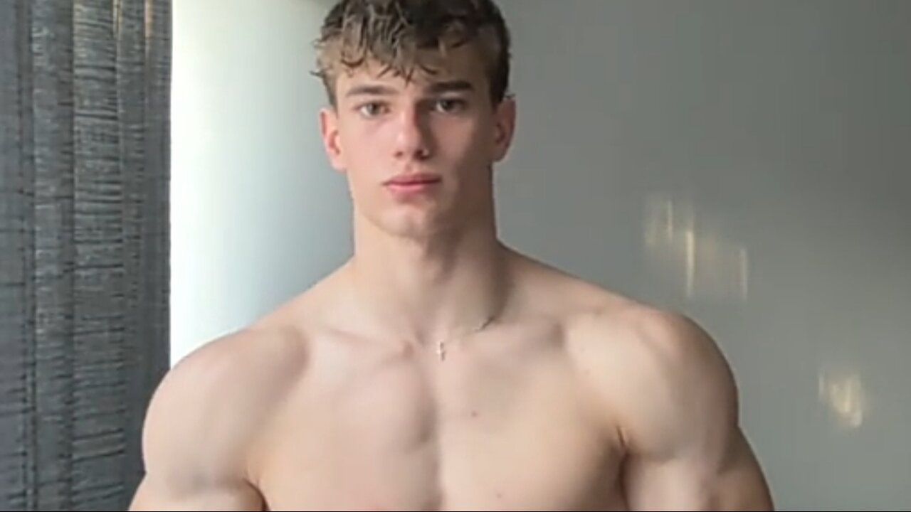 19 years old aesthetic bodybuilder flexing muscles