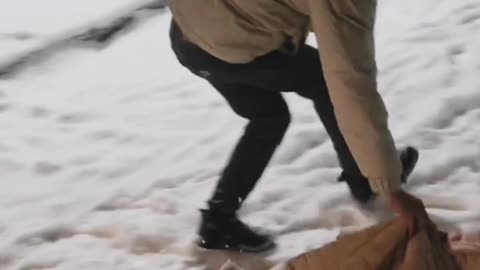 'Watch little kid is taking slides on snow with his dad'. 😊💕