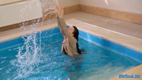 Wetlook girl in jeansand jacket gets wet in the pool