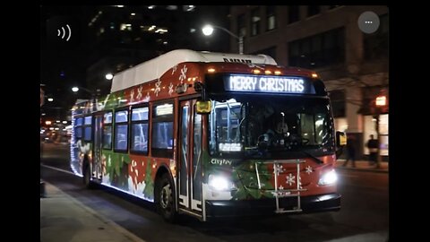 New flyer Xde40 xcelsior Citybus With Christmas Lights Driving On the Road