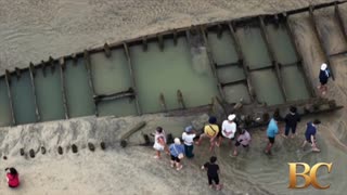 Typhoon reveals ancient ship buried for centuries