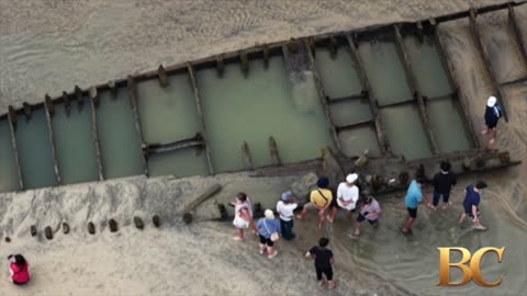 Typhoon reveals ancient ship buried for centuries