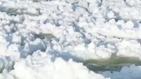 Aerial footage shows pancake ice rolling over waves on Lake Michigan, as cold