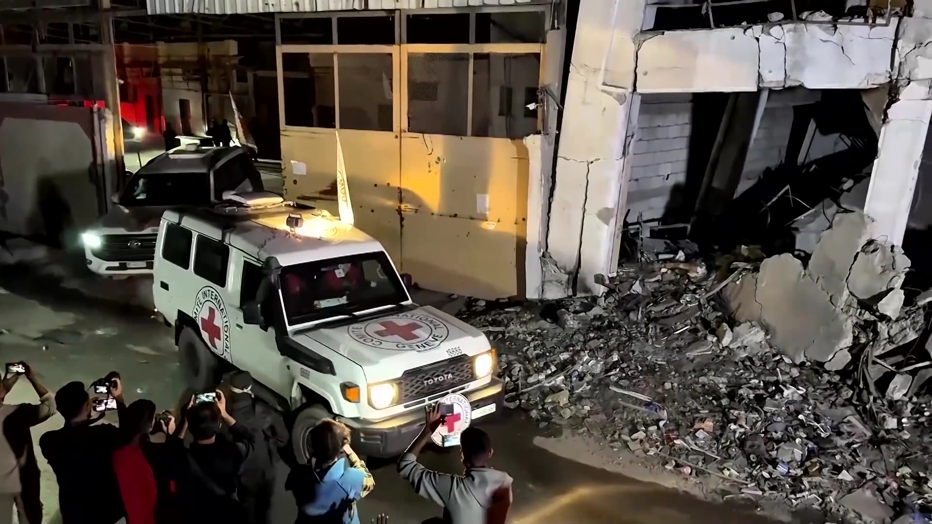 Red Cross vehicles drive bodies of deceased hostages out of Gaza