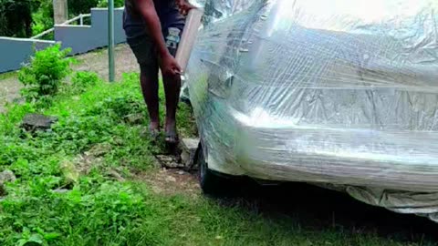Shrink Wrapping Car To Protect From Hurricane Mellissa