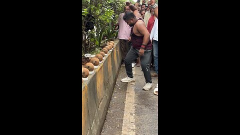 Hand breaking coconut in seconds