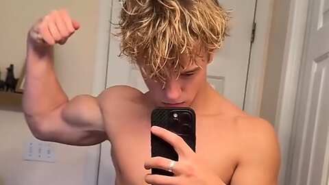 16 years old teen boy flexing muscles