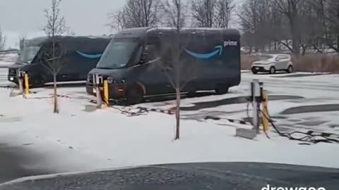 Amazon electric vehicles seen charging in the snow