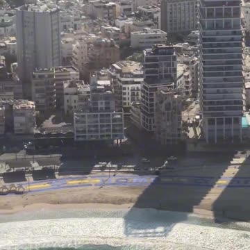 Air Force One flies over sign thanking President Trump on the beach of Tel Aviv!