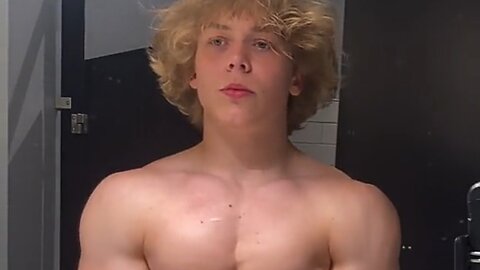16 years old teen boy flexing muscles