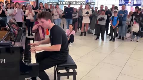 a pianist playing a nice music in public