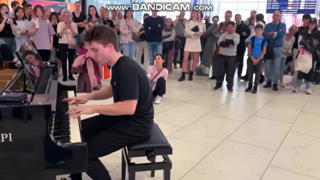 a pianist playing a nice music in public