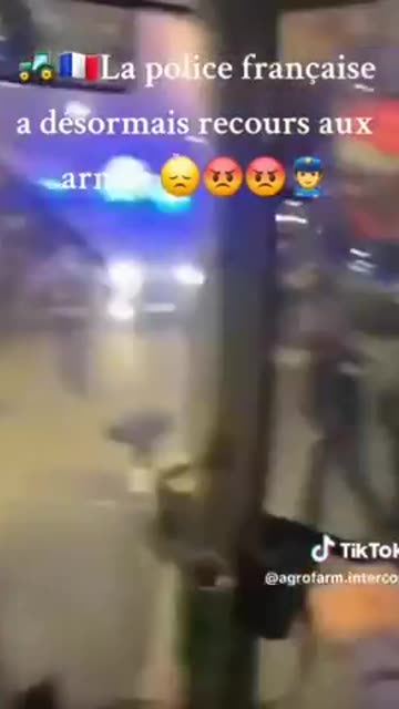 French police pull out guns on angry farmers protesting.