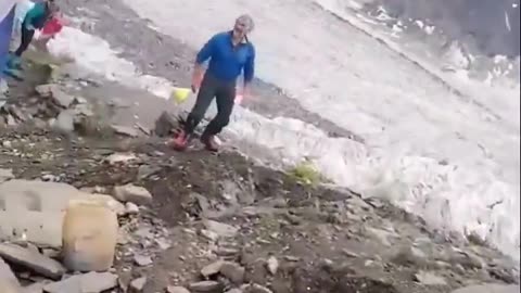 A giant rock rolling down a mountain just misses a camp and a couple people.😬