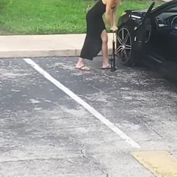 Woman Fixing A Flat Tire LOL