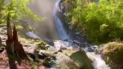 Cascade and waterfall in Altai Republic forest