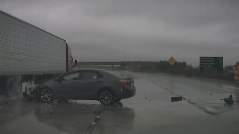 Allegedly Speeding Car Loses Control in Heavy Rain