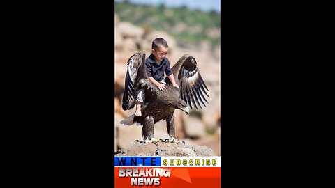 The little boy rode on the eagle's back.
