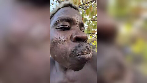 A savage African eats a dog